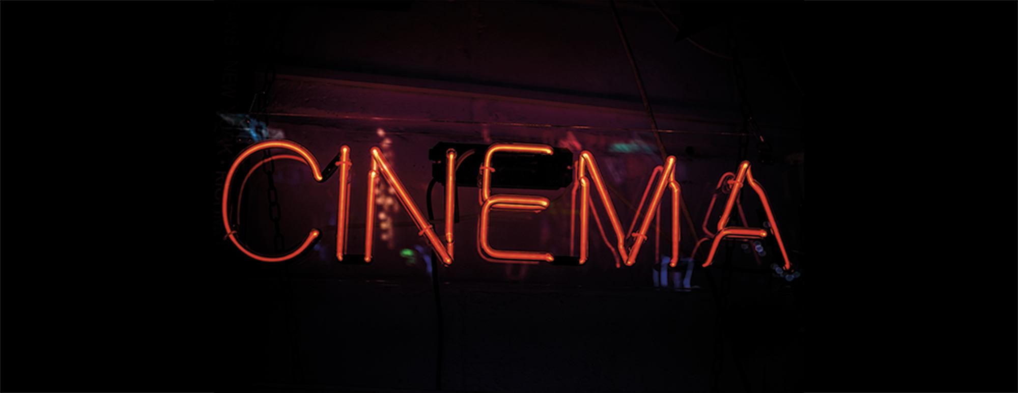 Glowing red sign saying 'cinema', horizontal with plenty of copy space.